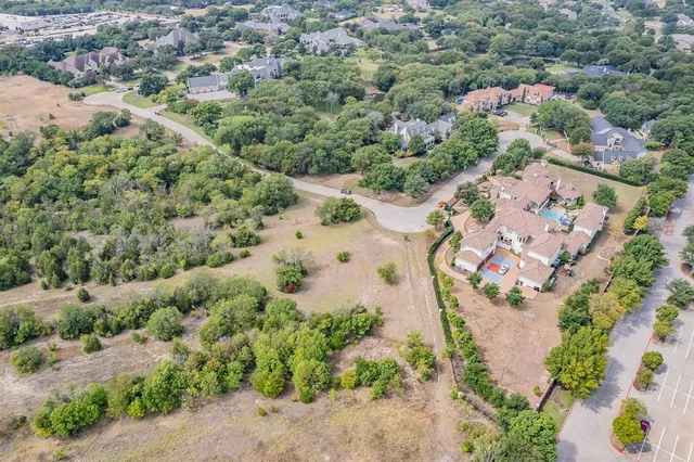 an aerial view of a house with a yard and lake view