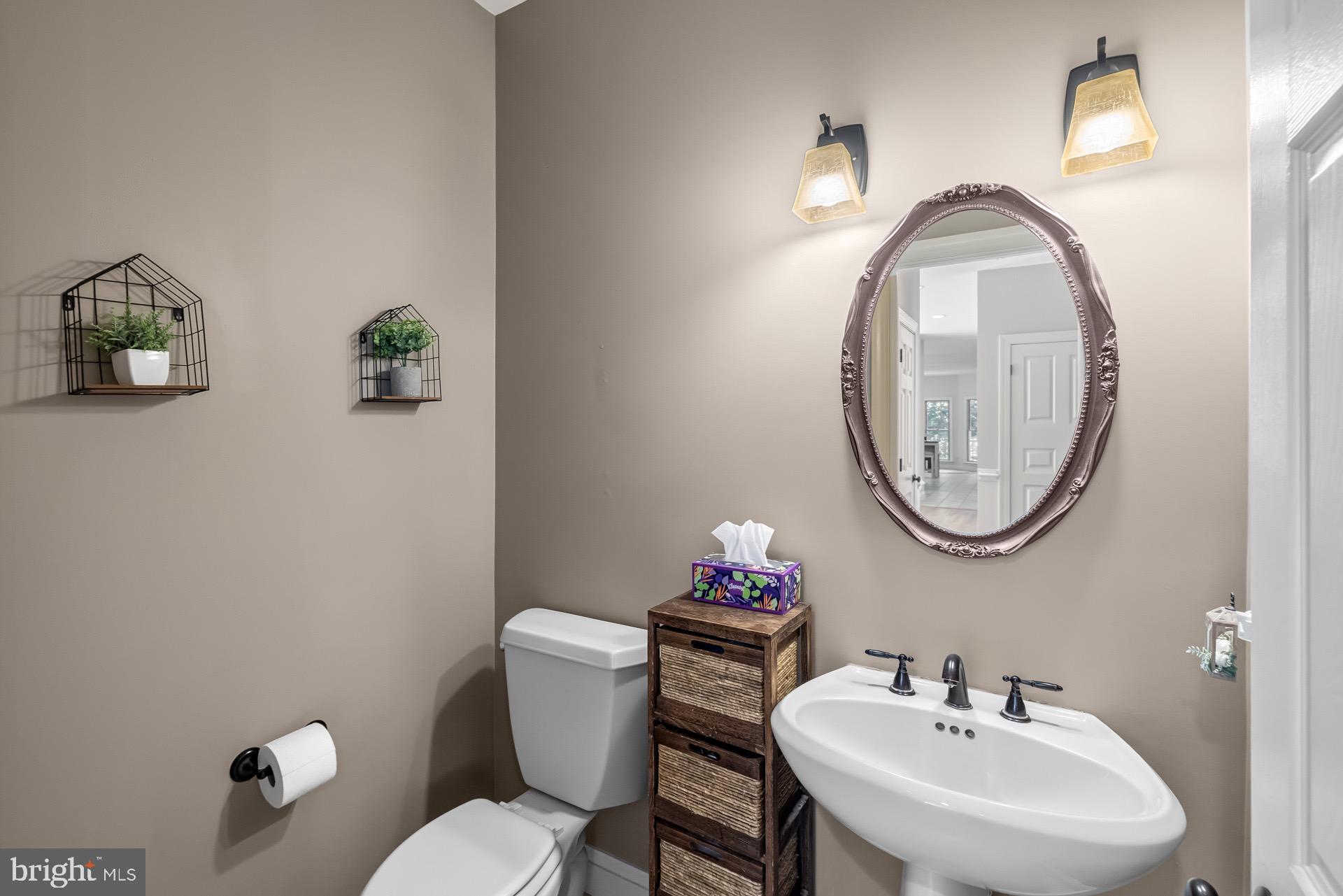 99 Hummingbird Court Dunkirk, MD 20754 - Photo 13 of 82 a bathroom with a toilet a sink and mirror