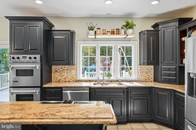 a view of a dining room with furniture a chandelier and wooden floor