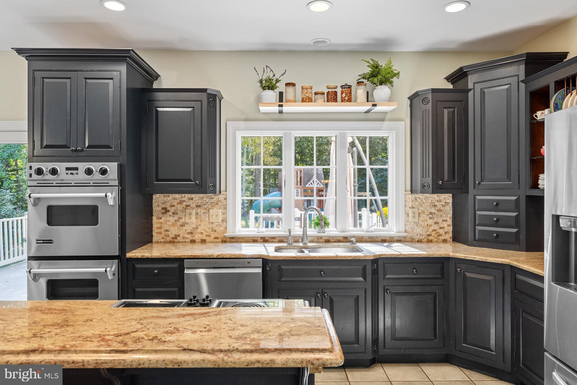 99 Hummingbird Court Dunkirk, MD 20754 - Photo 19 of 82 a kitchen with stainless steel appliances granite countertop a stove and a refrigerator