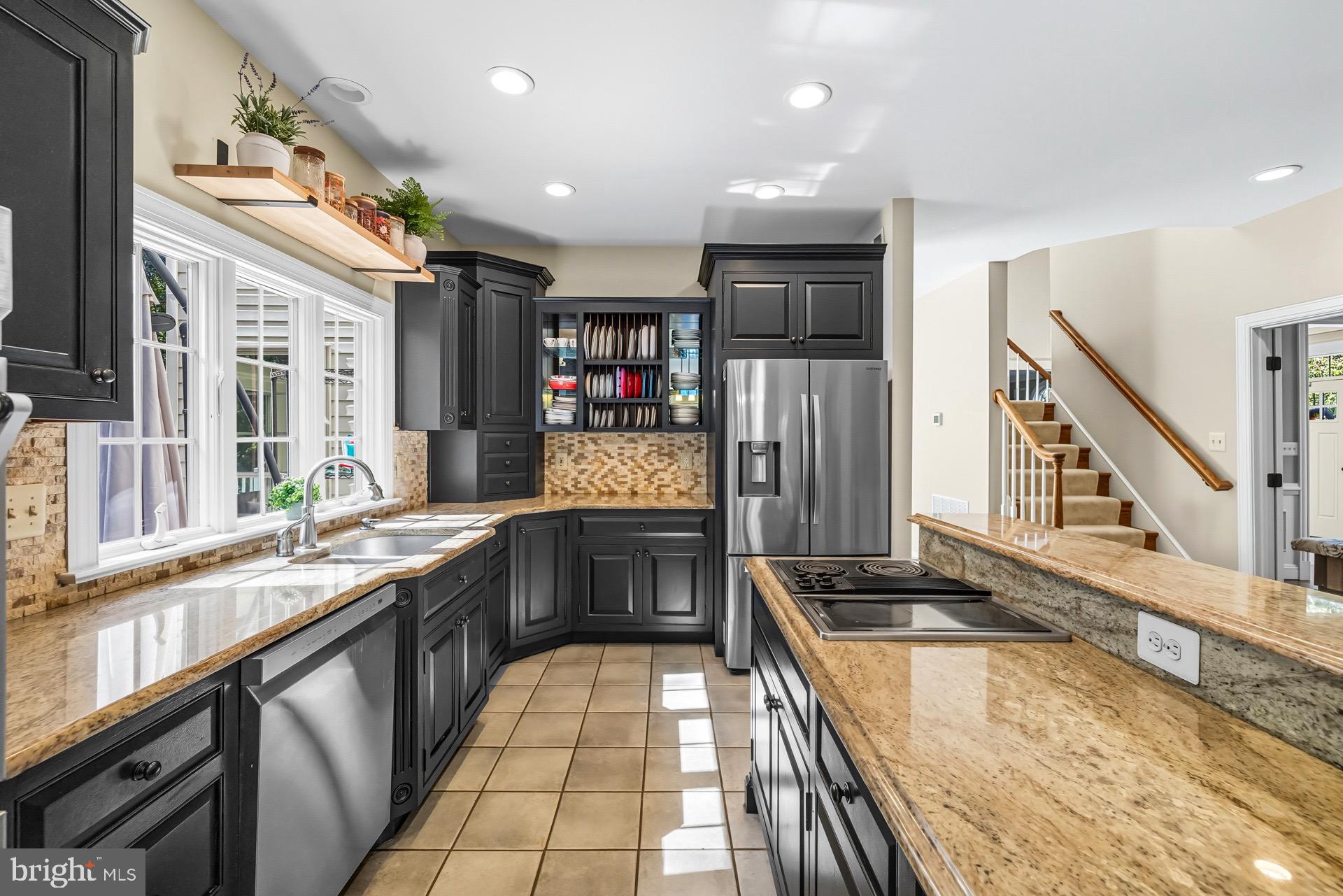 99 Hummingbird Court Dunkirk, MD 20754 - Photo 21 of 82 a kitchen with stainless steel appliances granite countertop a sink and wooden cabinets
