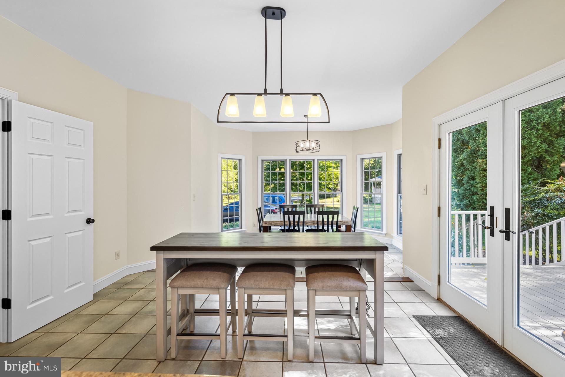 99 Hummingbird Court Dunkirk, MD 20754 - Photo 23 of 82 a dining room with table chairs and chandelier