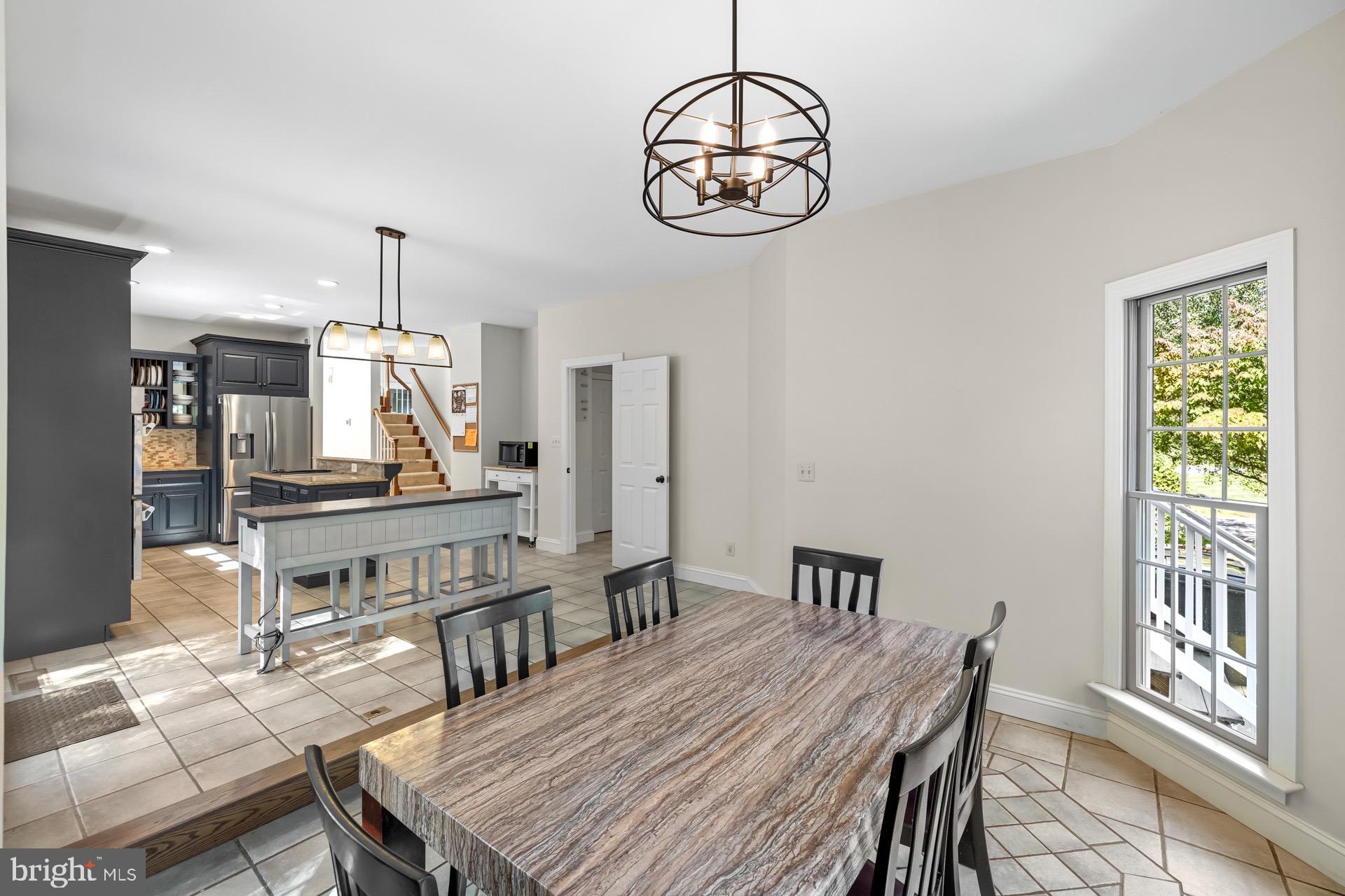99 Hummingbird Court Dunkirk, MD 20754 - Photo 26 of 82 a view of a dining room with furniture a chandelier and wooden floor