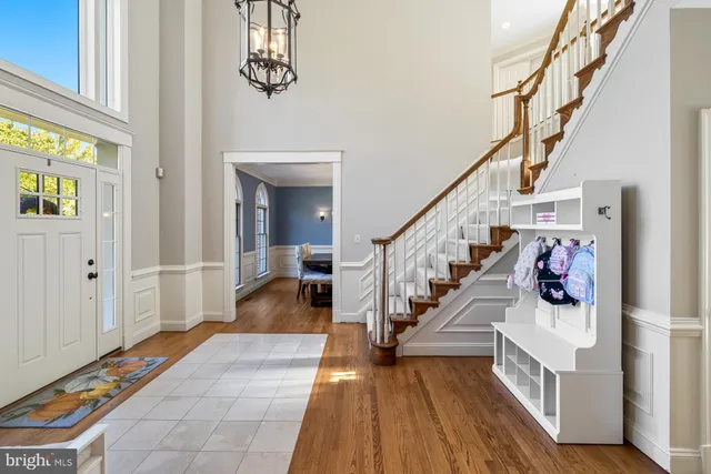 a view of entryway and hall with wooden floor