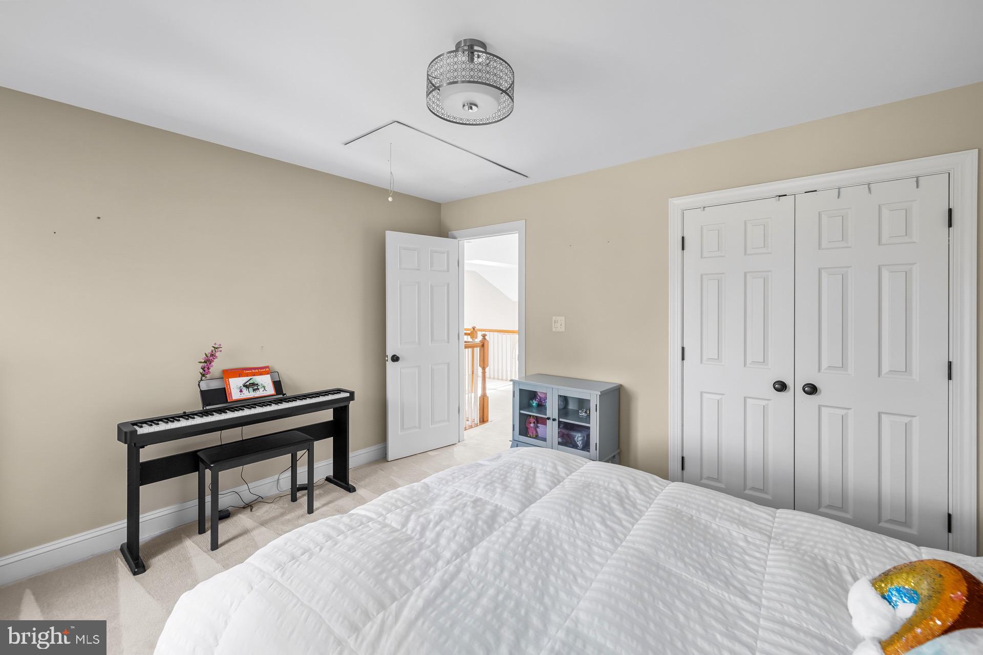 99 Hummingbird Court Dunkirk, MD 20754 - Photo 38 of 82 a bedroom with a bed and a chandelier