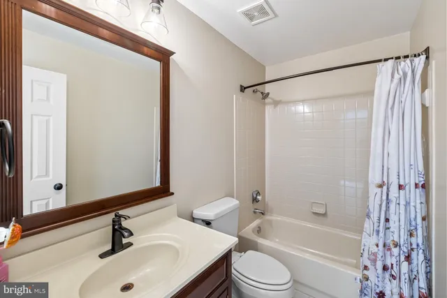 a bedroom with furniture and a flat screen tv