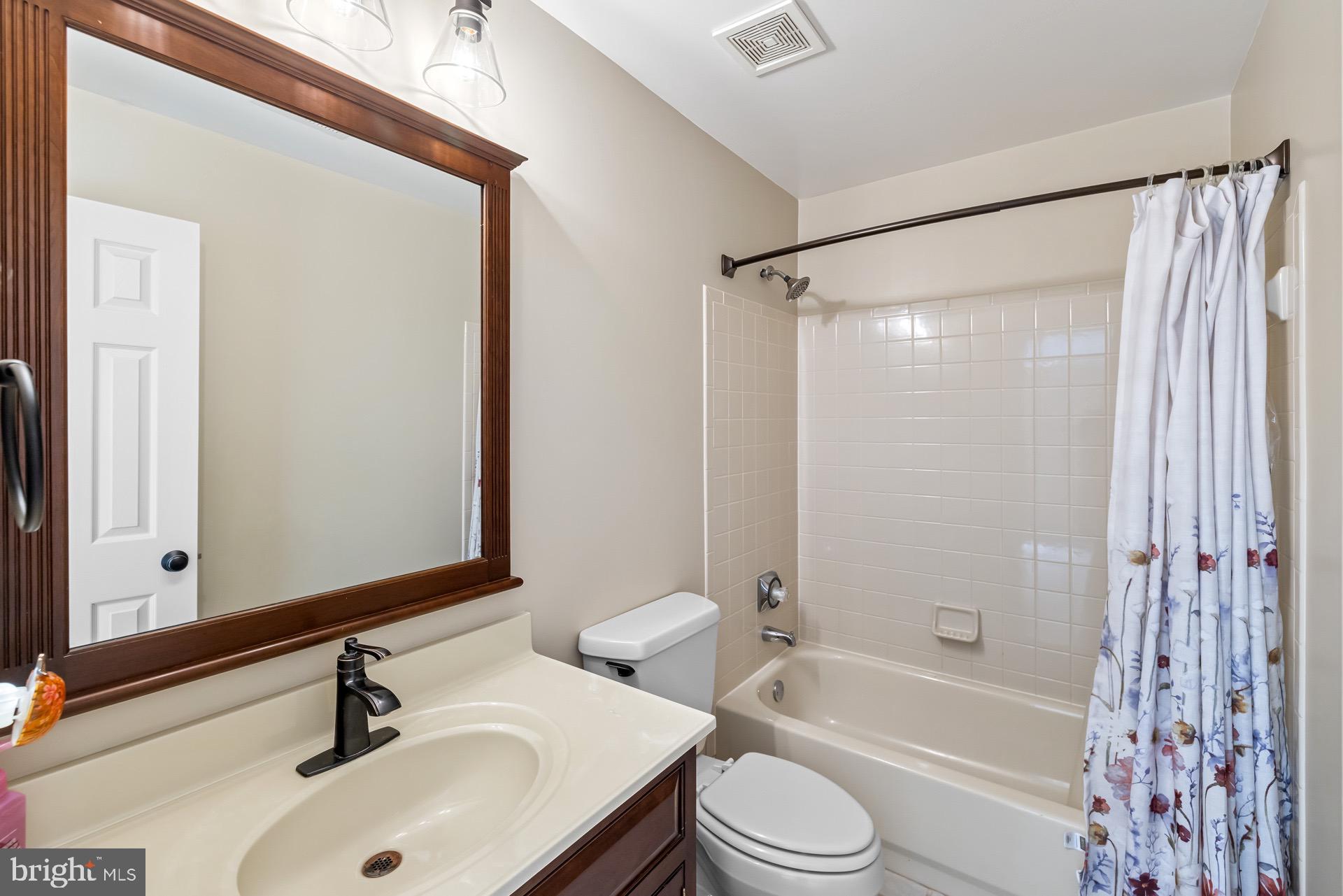 99 Hummingbird Court Dunkirk, MD 20754 - Photo 39 of 82 a bathroom with a sink and a mirror