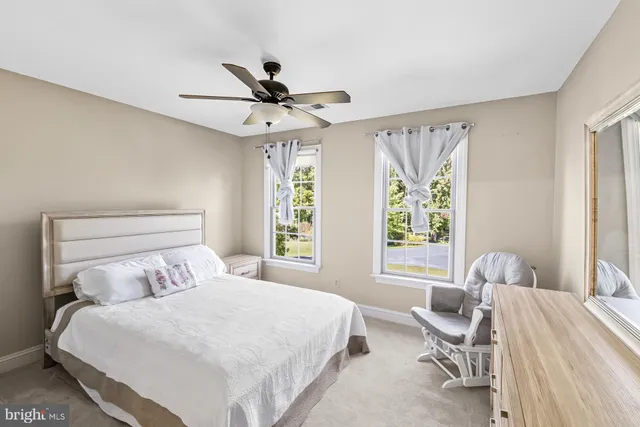 a spacious bedroom with a large bed and a large window