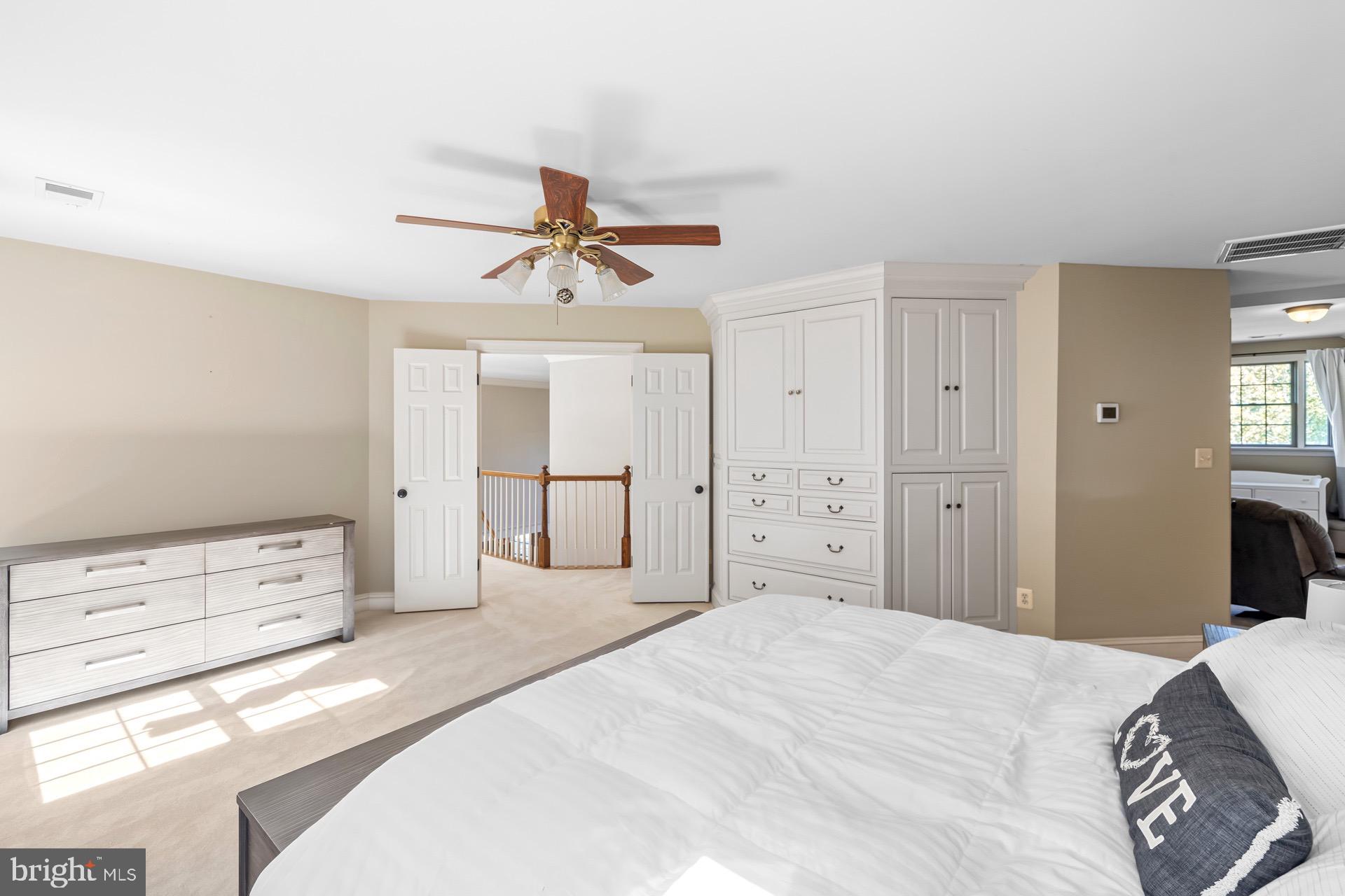 99 Hummingbird Court Dunkirk, MD 20754 - Photo 45 of 82 a bedroom with a bed and a chandelier