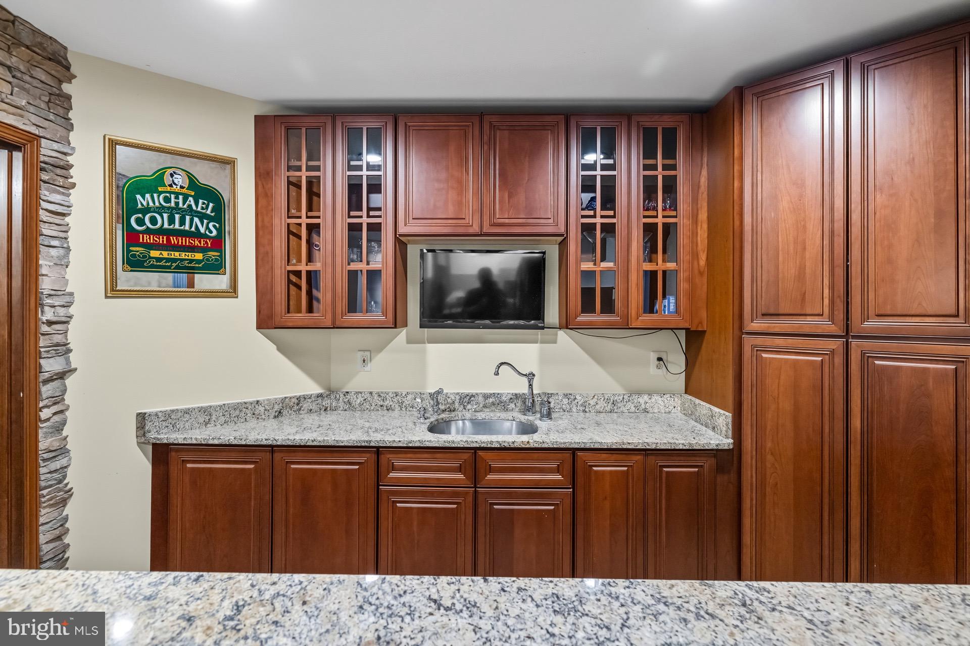 99 Hummingbird Court Dunkirk, MD 20754 - Photo 64 of 82 a kitchen with stainless steel appliances granite countertop wooden cabinets a sink and dishwasher