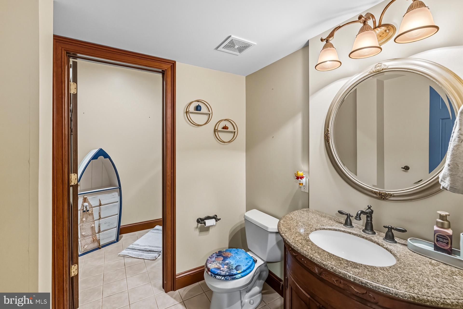 99 Hummingbird Court Dunkirk, MD 20754 - Photo 69 of 82 a bathroom with a granite countertop toilet sink and mirror