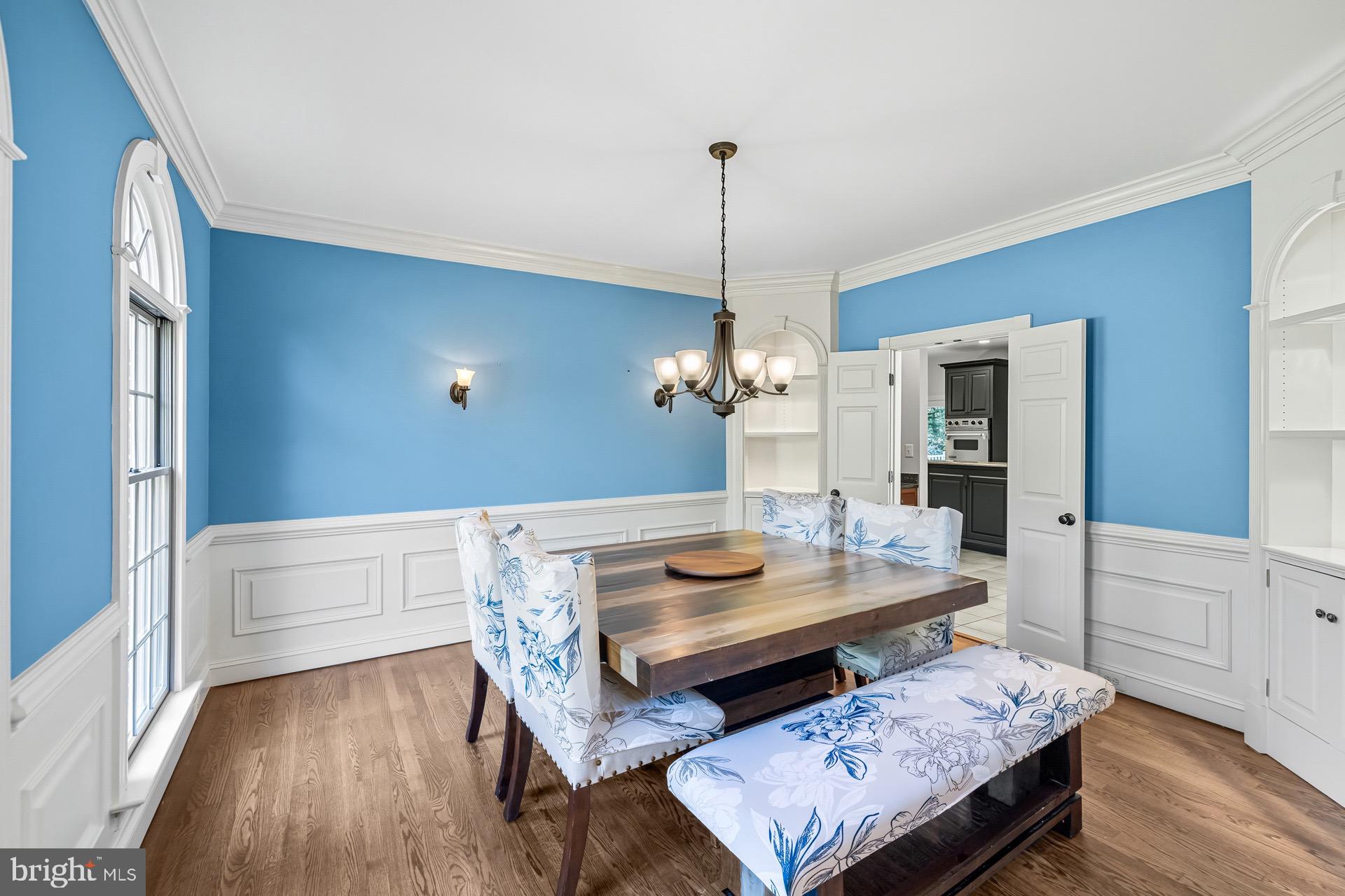 99 Hummingbird Court Dunkirk, MD 20754 - Photo 8 of 82 a living room with a table chairs and a wooden floor