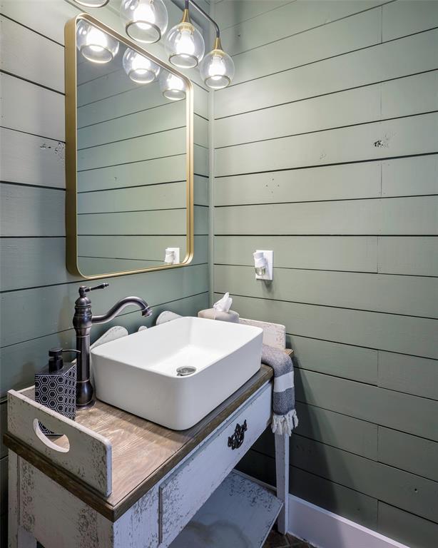 12345 Flow Road Krum, TX 76249 - Photo 13 of 38 Bathroom with wood walls and a sink