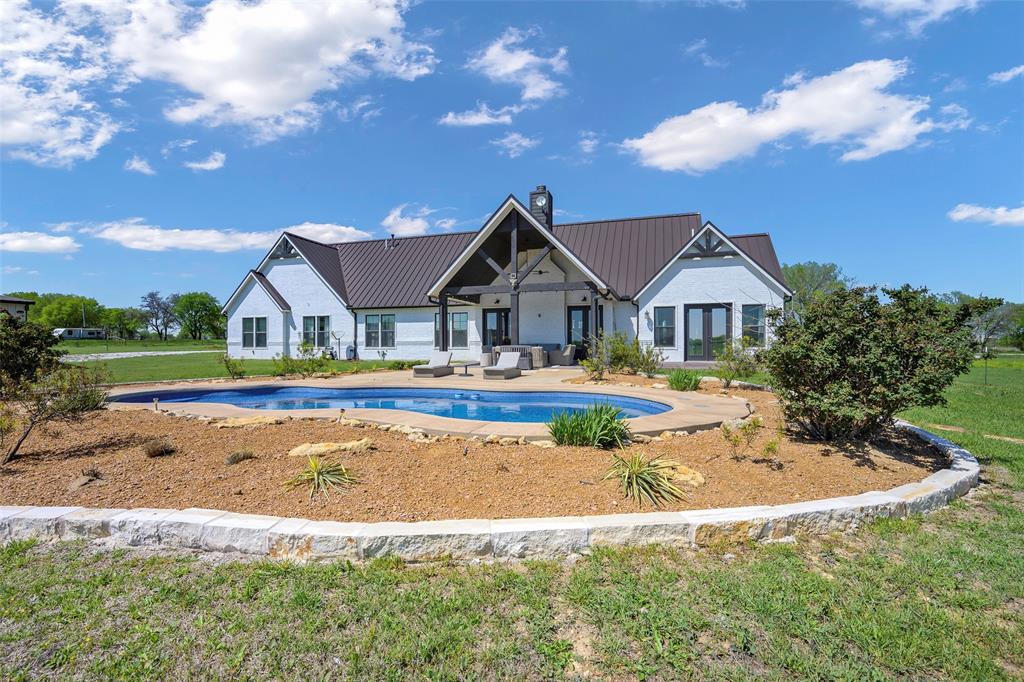 12345 Flow Road Krum, TX 76249 - Photo 30 of 38 Outdoor pool featuring a yard, outdoor lounge area, and a patio