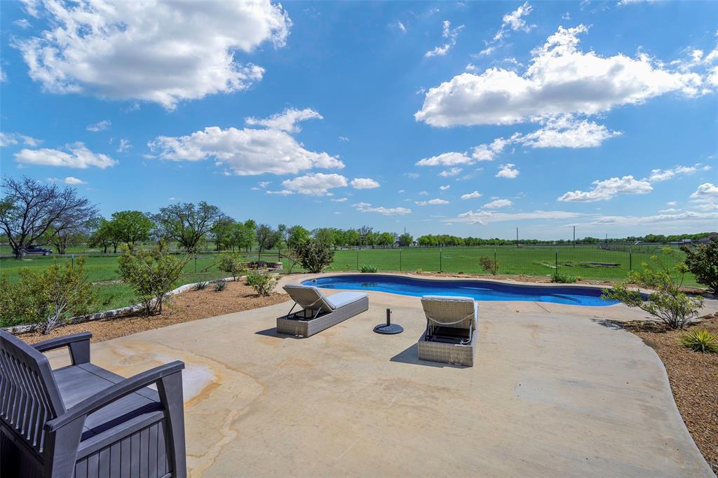 12345 Flow Road Krum, TX 76249 - Photo 32 of 38 View of swimming pool featuring a lawn, fence, a fenced in pool, and a patio area