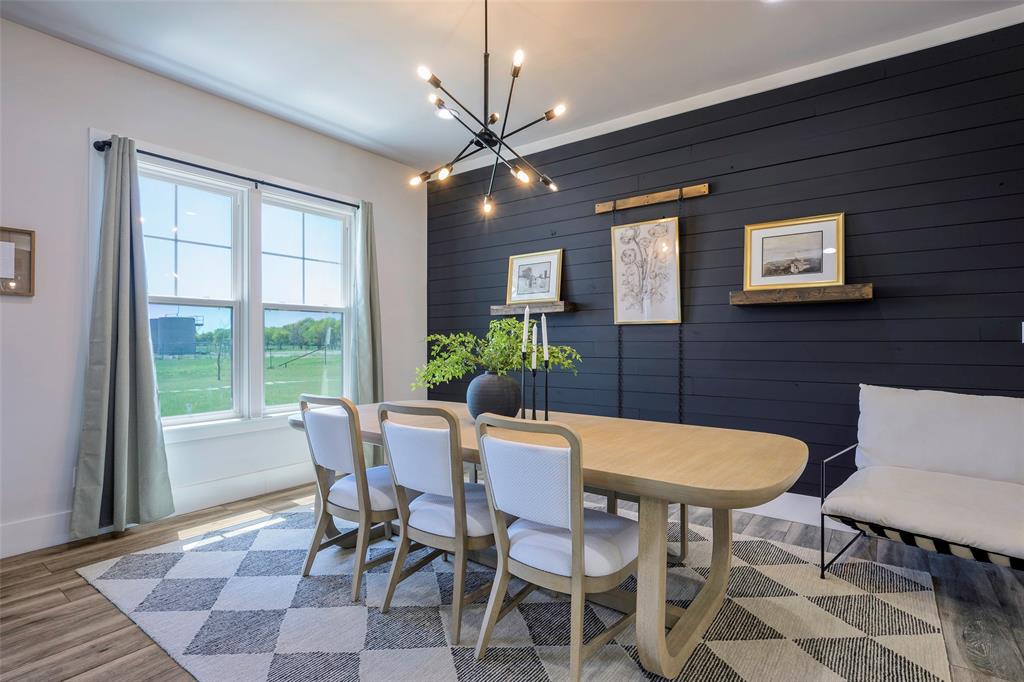 12345 Flow Road Krum, TX 76249 - Photo 7 of 38 Dining room with an inviting chandelier, wood finished floors, and baseboards