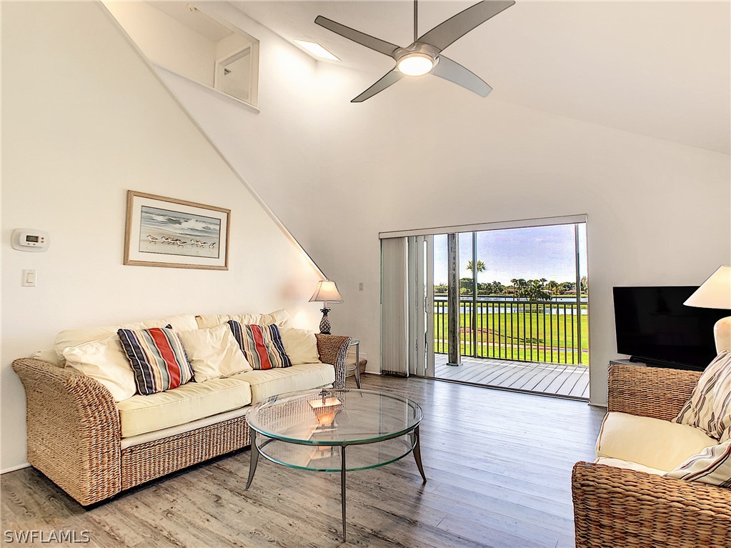 1645 Sand Castle Road Sanibel, FL 33957 - Photo 13 of 34 a living room with furniture and a wooden floor