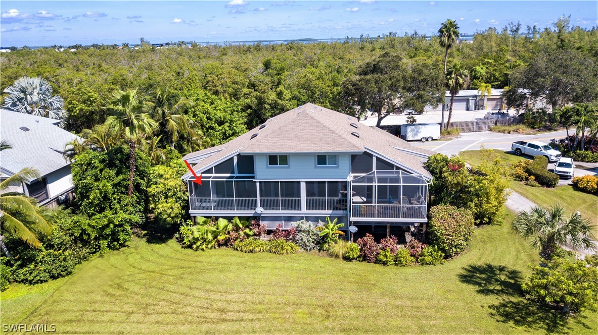 1645 Sand Castle Road Sanibel, FL 33957 - Photo 26 of 34 a front view of a house with a yard