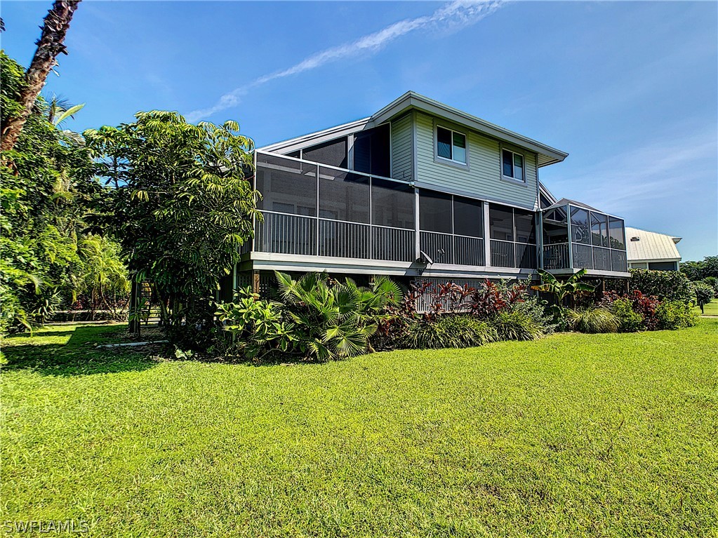 1645 Sand Castle Road Sanibel, FL 33957 - Photo 28 of 34 a front view of a house with a yard