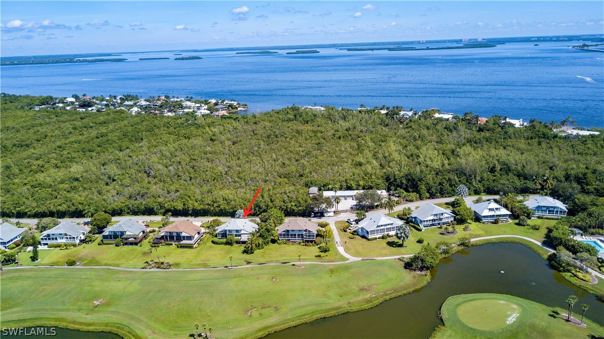 1645 Sand Castle Road Sanibel, FL 33957 - Photo 30 of 34 a view of a lake with a table and chairs