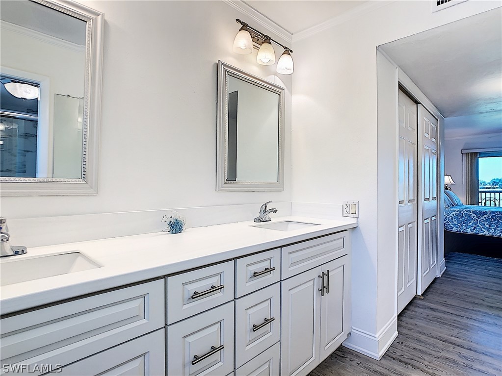 1645 Sand Castle Road Sanibel, FL 33957 - Photo 5 of 34 a bathroom with a double vanity sink and mirror