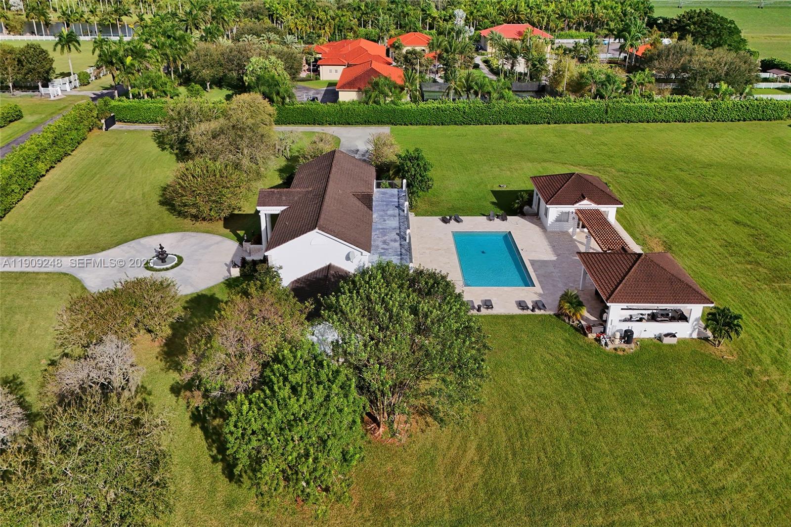 18300 Southwest 158th Street Miami, FL 33187 - Photo 34 of 100 an aerial view of a house with a garden and swimming pool