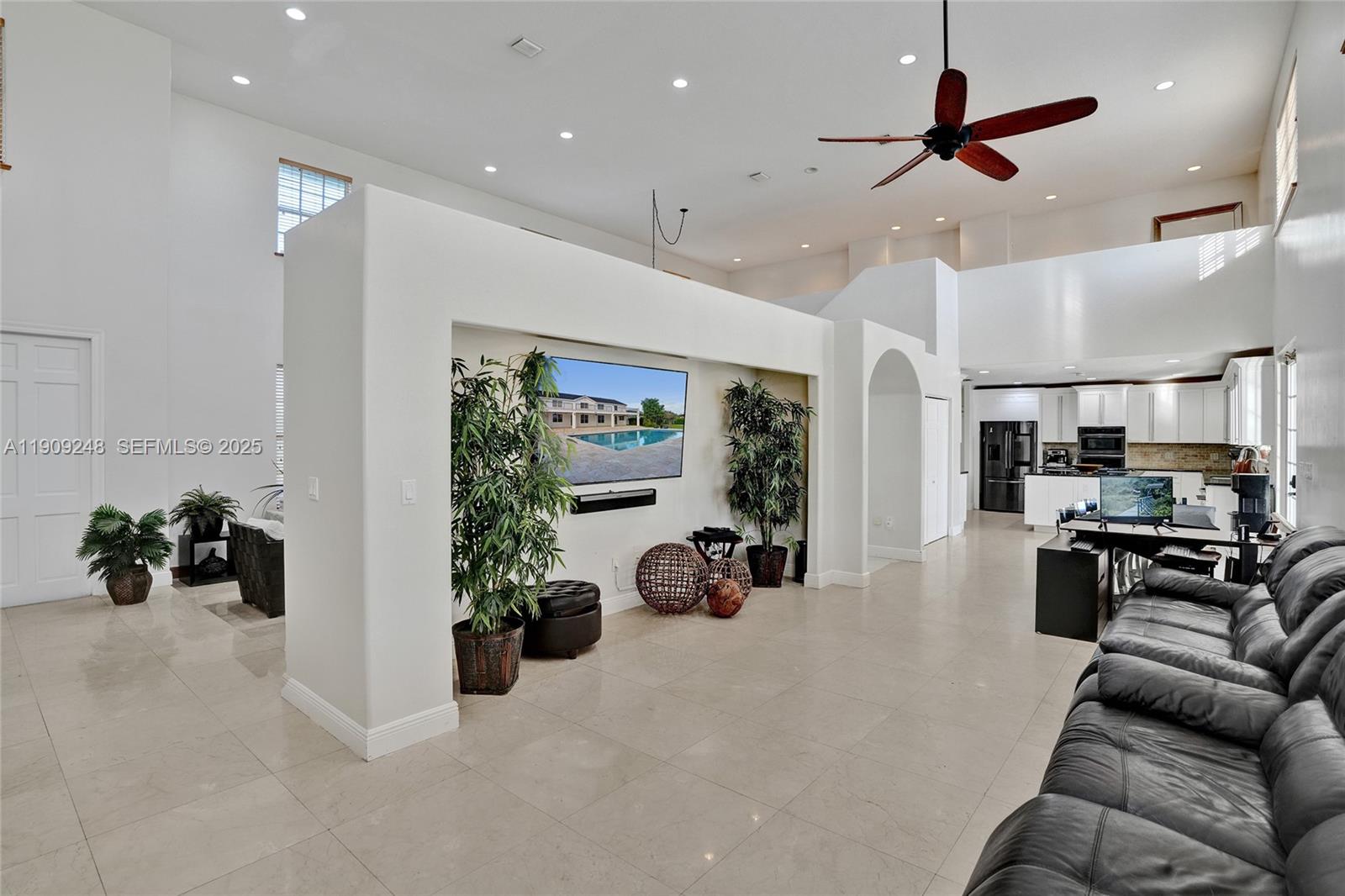 18300 Southwest 158th Street Miami, FL 33187 - Photo 54 of 100 a living room with furniture gym equipment and a large window