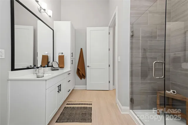 a bathroom with a double vanity sink and mirror