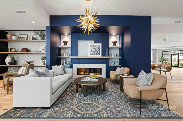 a living room with furniture a fireplace and wall paintings