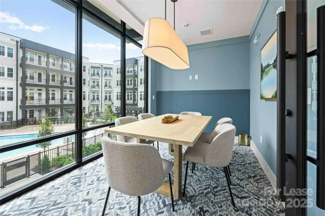 a view of a dining room with a table and chairs