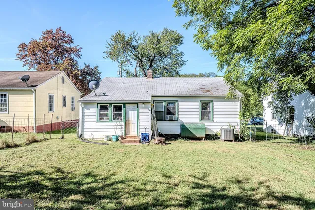 a view of a house with a yard and sitting area