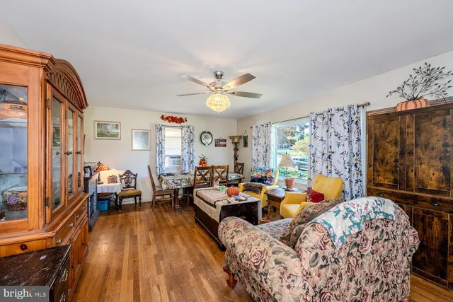 a living room with furniture fireplace and a large window