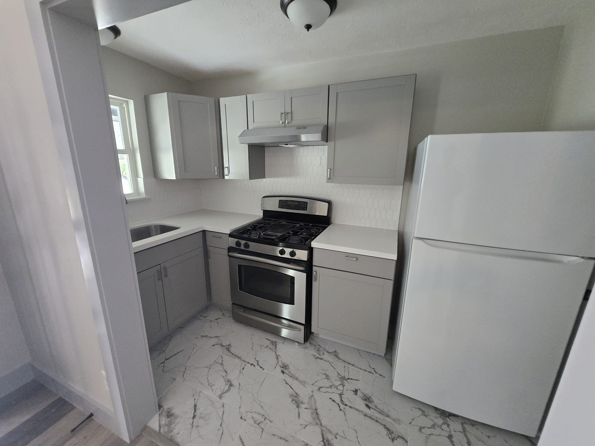 8335 Bonner Drive, Unit 2 Houston, TX 77017 - Photo 1 of 10 a kitchen with a refrigerator and a stove top oven