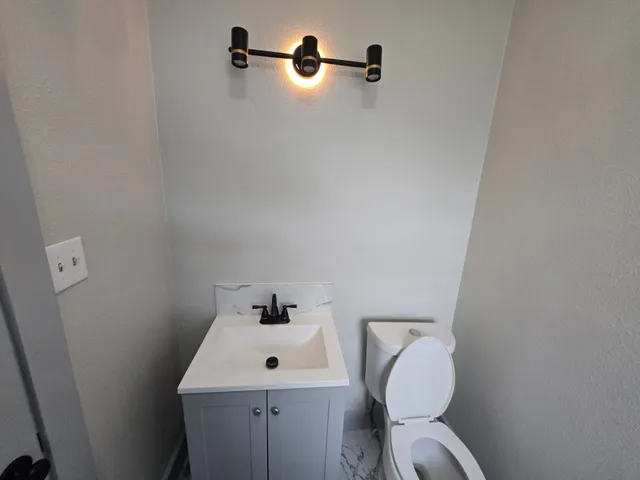 a bathroom with a toilet and a sink