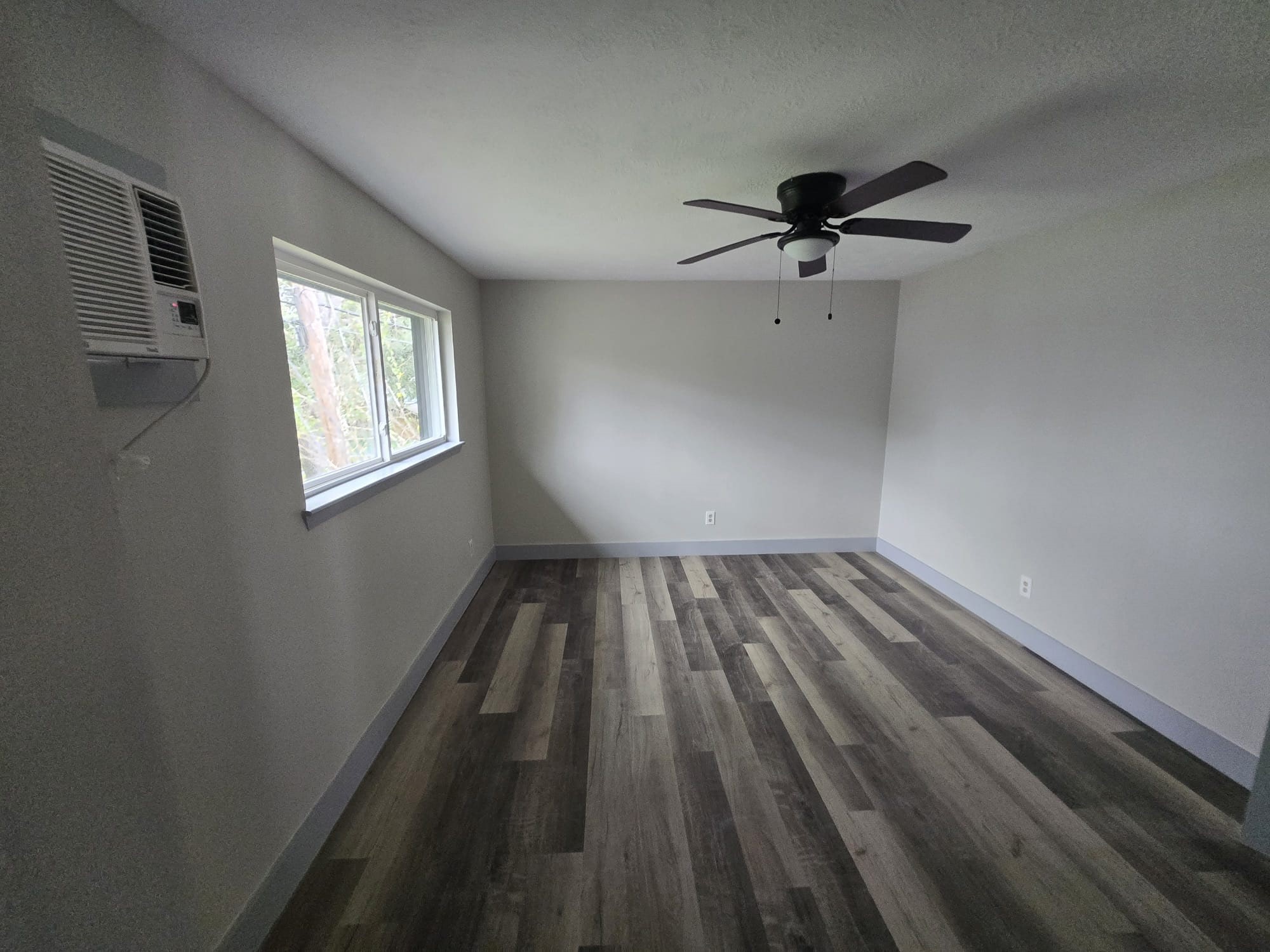 8335 Bonner Drive, Unit 2 Houston, TX 77017 - Photo 9 of 10 wooden floor in an empty room with a window