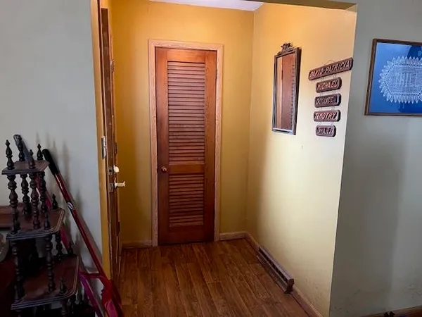 a view of a hallway with wooden floor