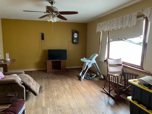 a bedroom with a bed and a wooden floor