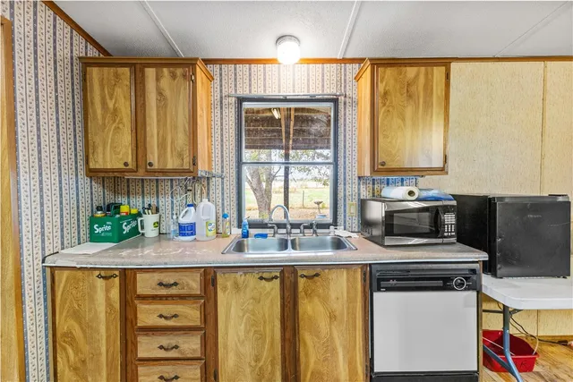 a view of a livingroom with wooden floor and furniture