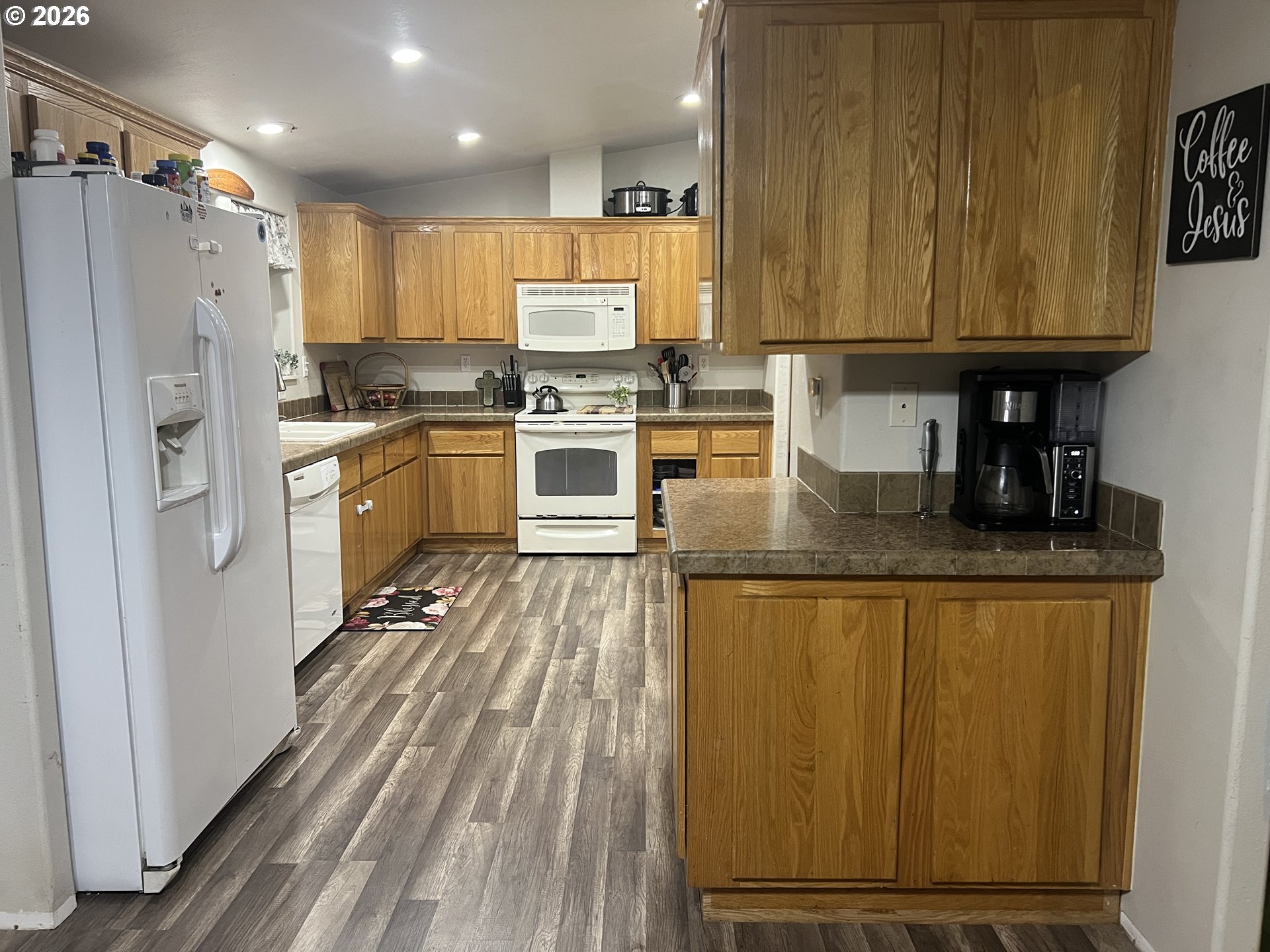 210 Northwest Grinstead Street Siletz, OR 97380 - Photo 11 of 29 a kitchen with granite countertop stainless steel appliances and refrigerator