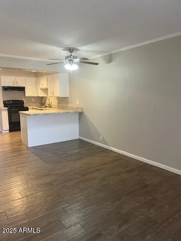 a view of a kitchen with kitchen island a sink counter top space and appliances
