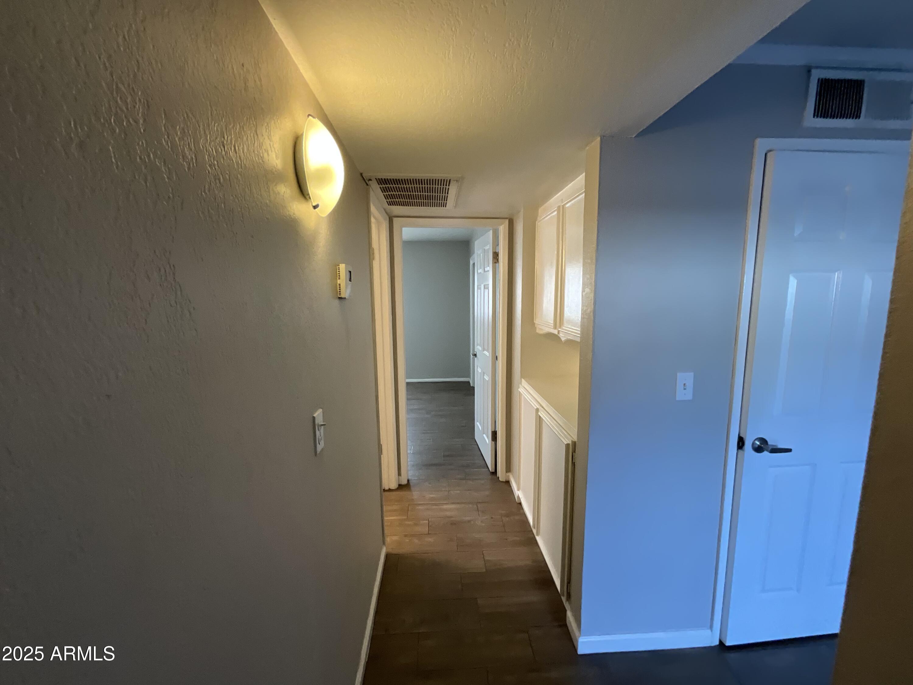810 East Colter Street, Unit 11 Phoenix, AZ 85014 - Photo 5 of 17 a view of a hallway with wooden floor