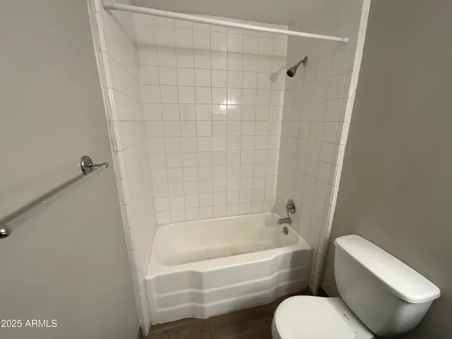 a bathroom with a toilet and bathtub