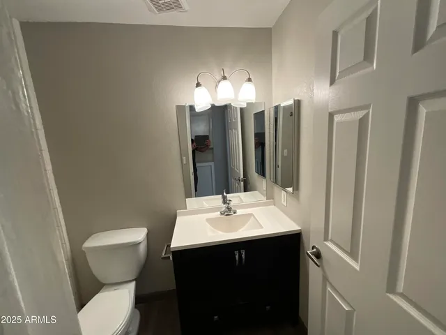 a bathroom with a sink toilet and a mirror