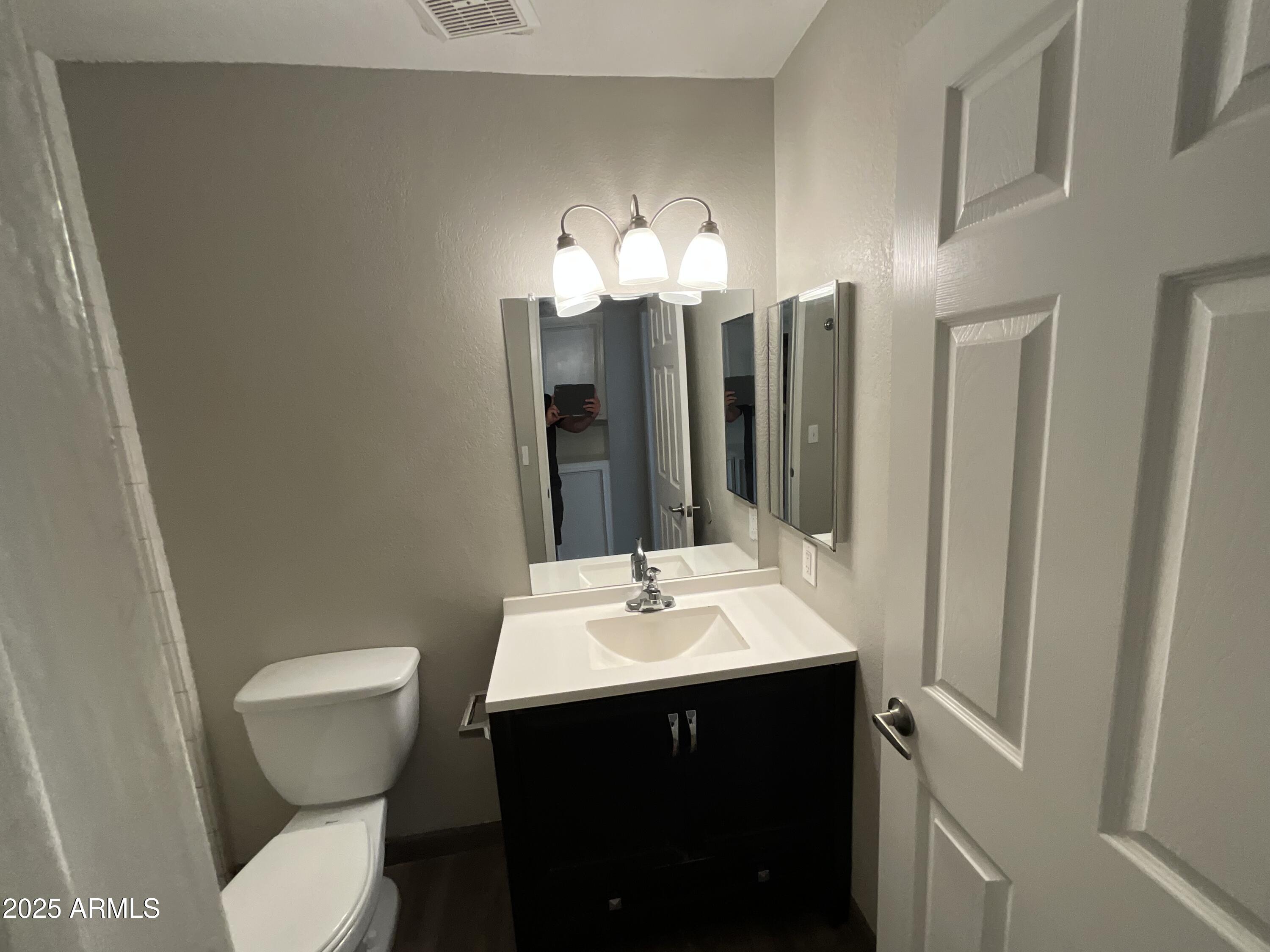 810 East Colter Street, Unit 11 Phoenix, AZ 85014 - Photo 7 of 17 a bathroom with a sink toilet and a mirror