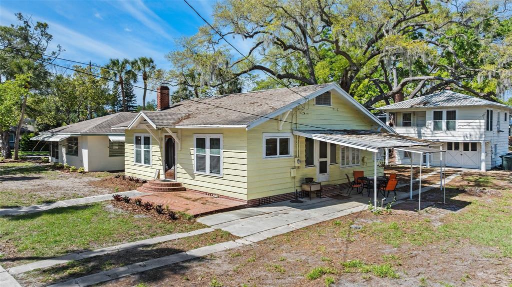 a house with lawn chairs in front of it
