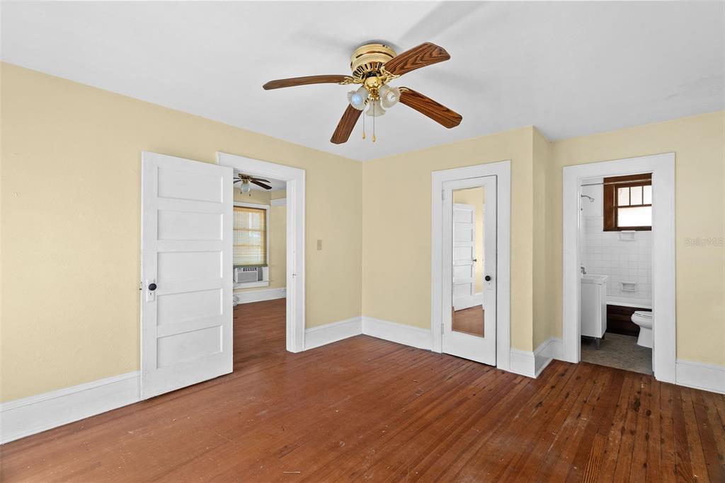 300 President Street Dunedin, FL 34698 - Photo 18 of 53 a view of empty room with wooden floor and ceiling fan
