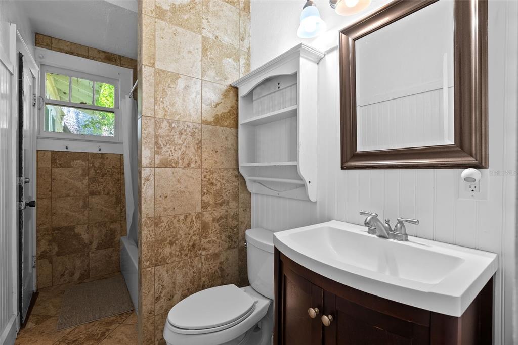 300 President Street Dunedin, FL 34698 - Photo 20 of 53 a bathroom with a sink a toilet and shower