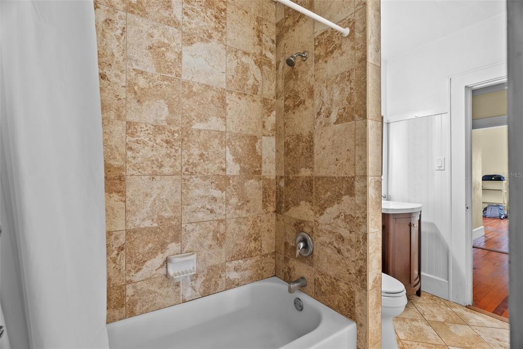 300 President Street Dunedin, FL 34698 - Photo 21 of 53 a bathroom with a bathtub and shower