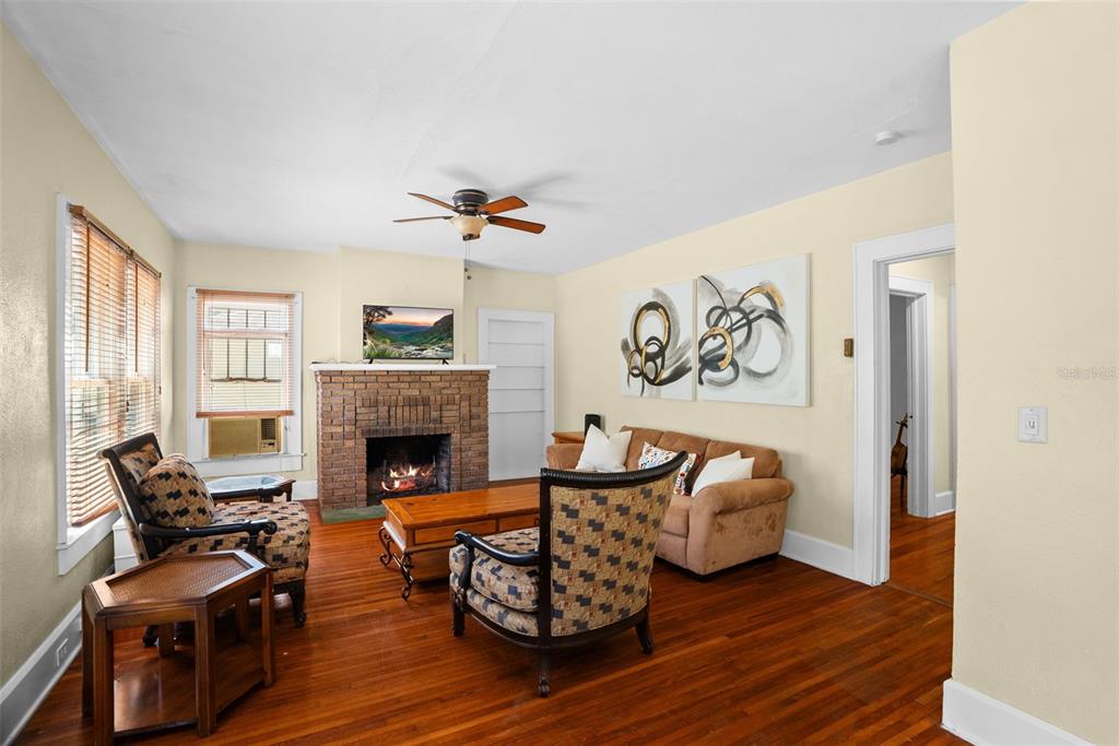 300 President Street Dunedin, FL 34698 - Photo 24 of 53 a living room with furniture and a fireplace