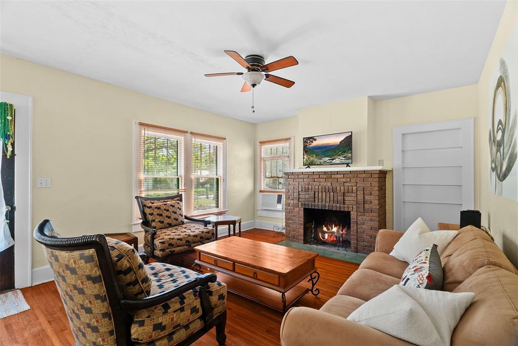 300 President Street Dunedin, FL 34698 - Photo 26 of 53 a living room with furniture and a fireplace